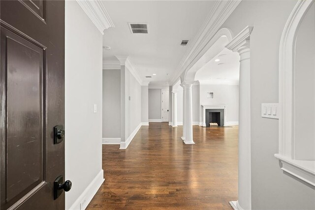 hall featuring ornamental molding, ornate columns, and dark hardwood / wood-style floors