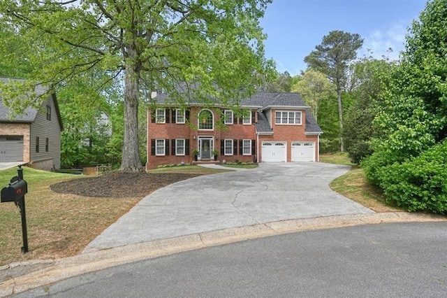 3130 Crestmont Way NW, Kennesaw, GA 30152 - colonial-style house featuring asphalt driveway, a garage, and brick siding
