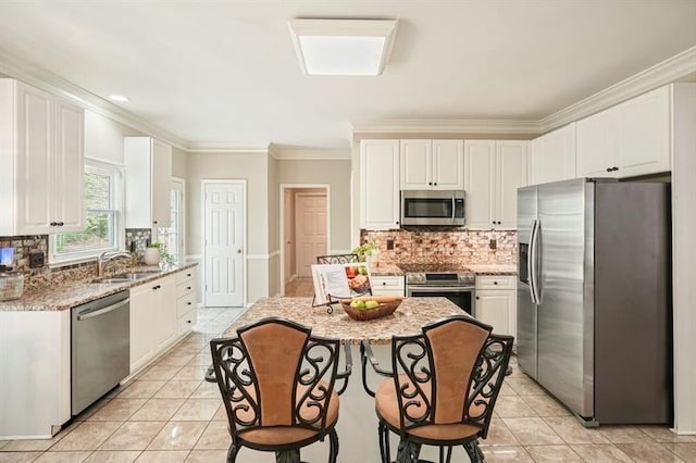 3130 Crestmont Way NW, Kennesaw, GA 30152 - kitchen with stainless steel appliances, a sink, tasteful backsplash, light tile patterned floors, and crown molding