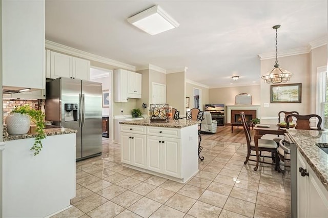 3130 Crestmont Way NW, Kennesaw, GA 30152 - kitchen featuring stainless steel fridge with ice dispenser, crown molding, open floor plan, white cabinetry, and light stone counters