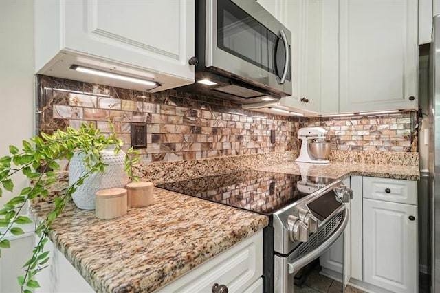 3130 Crestmont Way NW, Kennesaw, GA 30152 - kitchen with appliances with stainless steel finishes, white cabinets, decorative backsplash, and light stone counters