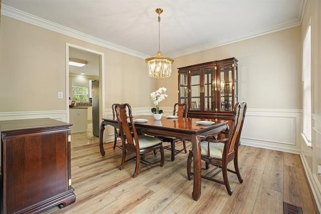 3130 Crestmont Way NW, Kennesaw, GA 30152 - dining space with a chandelier, light wood finished floors, wainscoting, ornamental molding, and a decorative wall