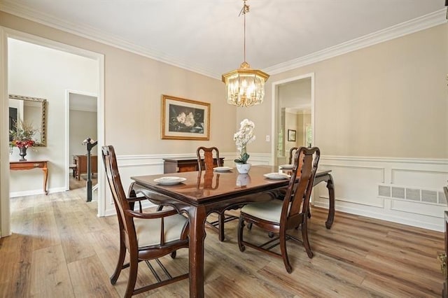 3130 Crestmont Way NW, Kennesaw, GA 30152 - dining room with light wood-style floors, a chandelier, ornamental molding, and wainscoting