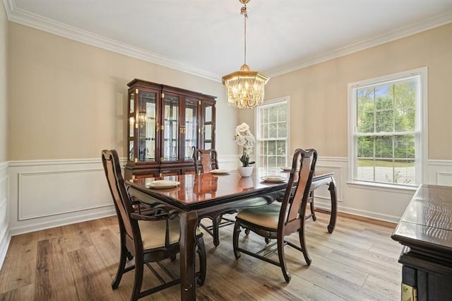 3130 Crestmont Way NW, Kennesaw, GA 30152 - dining area with a chandelier, light wood-type flooring, a wainscoted wall, and ornamental molding