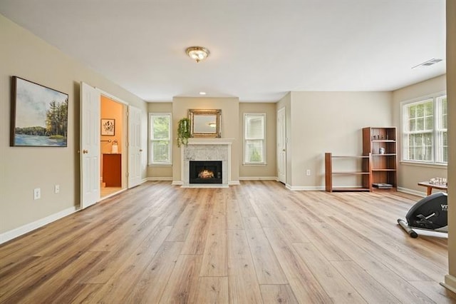 3130 Crestmont Way NW, Kennesaw, GA 30152 - unfurnished living room with light wood finished floors, healthy amount of natural light, and baseboards