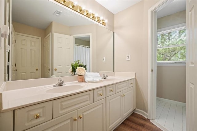 3130 Crestmont Way NW, Kennesaw, GA 30152 - bathroom with double vanity, baseboards, and wood finished floors