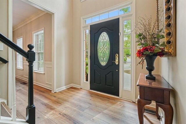 3130 Crestmont Way NW, Kennesaw, GA 30152 - foyer entrance featuring crown molding, light wood-type flooring, healthy amount of natural light, and stairway
