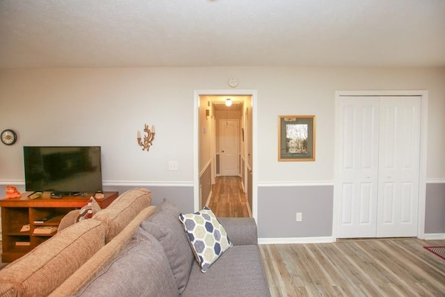 living room featuring baseboards and wood finished floors