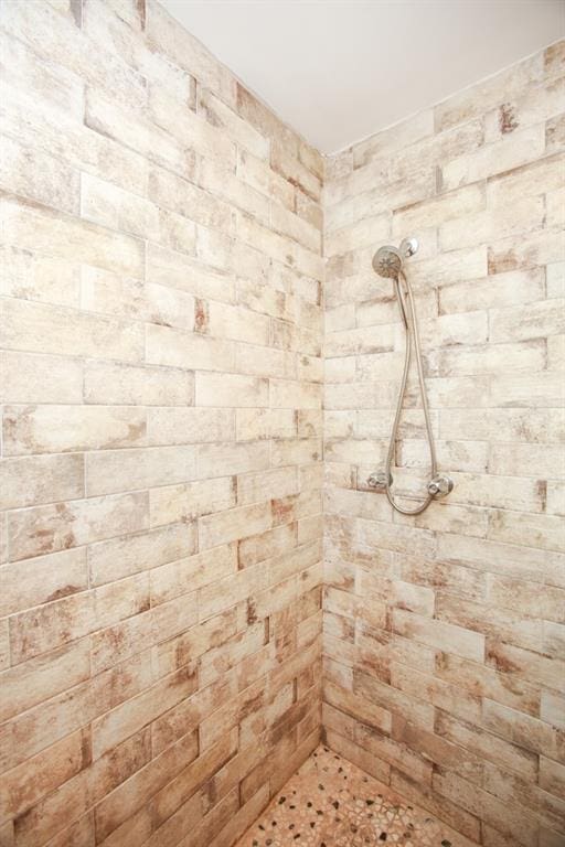 bathroom with a tile shower