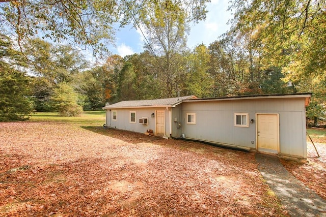 rear view of house featuring a wall mounted air conditioner