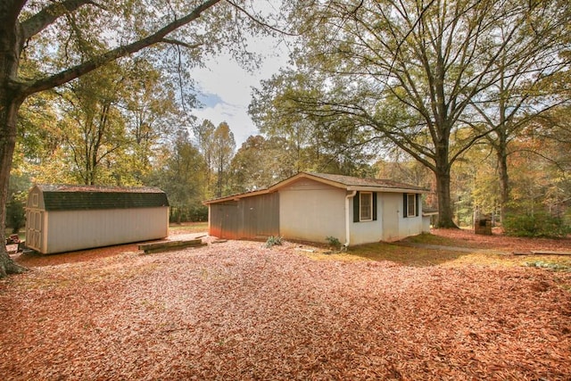 view of home's exterior with a storage shed