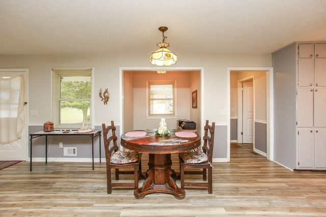 dining area featuring light wood-type flooring