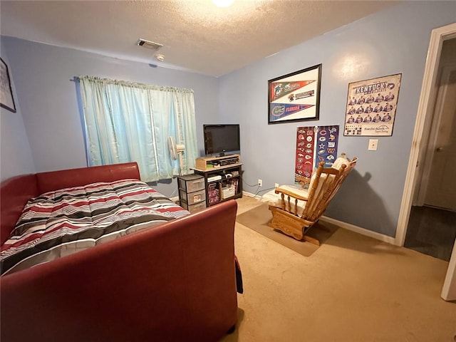 carpeted bedroom featuring a textured ceiling, visible vents, and baseboards