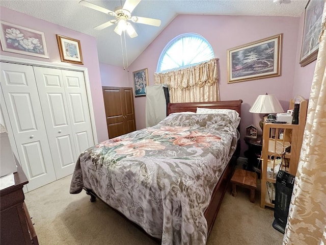 bedroom featuring lofted ceiling, ceiling fan, a closet, and light carpet