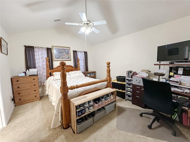 bedroom with visible vents, a ceiling fan, light carpet, and vaulted ceiling