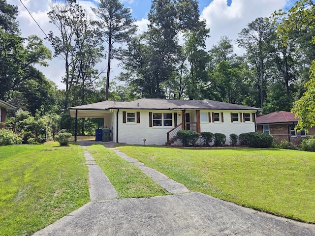 view of front of home with an attached carport, driveway, and a front yard