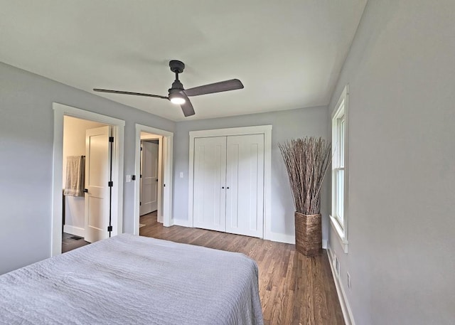 bedroom with dark wood-style flooring, a closet, a ceiling fan, and baseboards