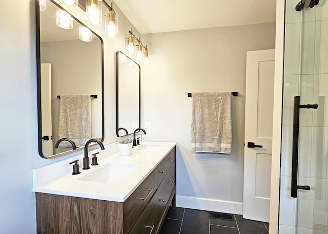 full bath with double vanity, a sink, tile patterned floors, and baseboards
