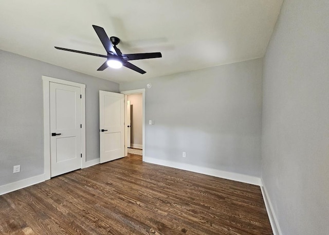 unfurnished bedroom with baseboards, wood finished floors, and ceiling fan