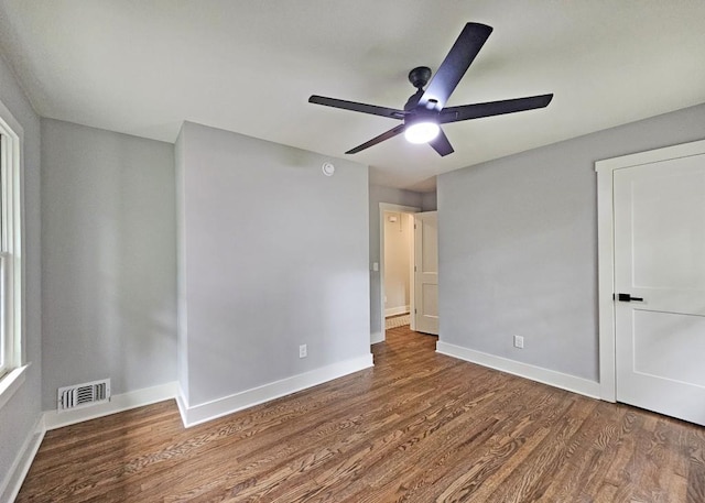 unfurnished bedroom featuring visible vents, ceiling fan, wood finished floors, and baseboards