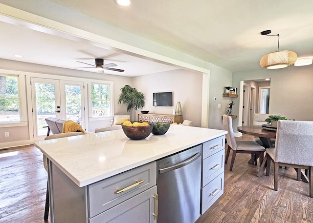 kitchen with dark wood finished floors, gray cabinets, stainless steel dishwasher, and open floor plan
