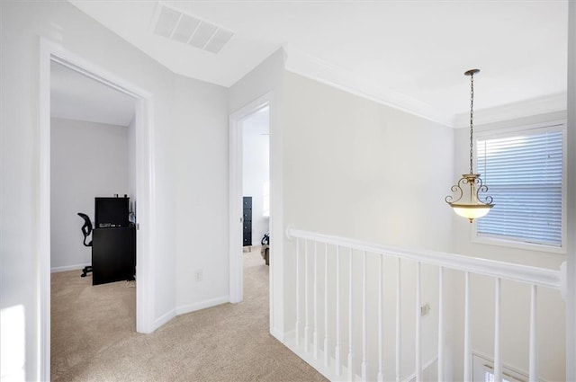 corridor with light colored carpet and ornamental molding