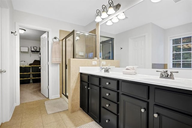 bathroom with tile patterned flooring, vanity, and a shower with shower door