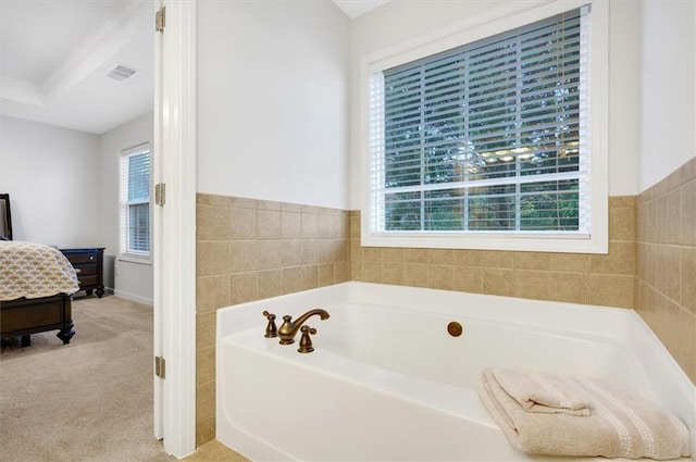 bathroom with a washtub and tile walls