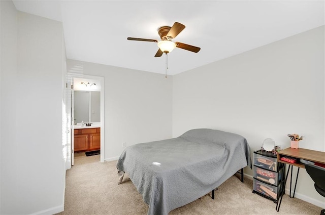 carpeted bedroom with ensuite bathroom and ceiling fan