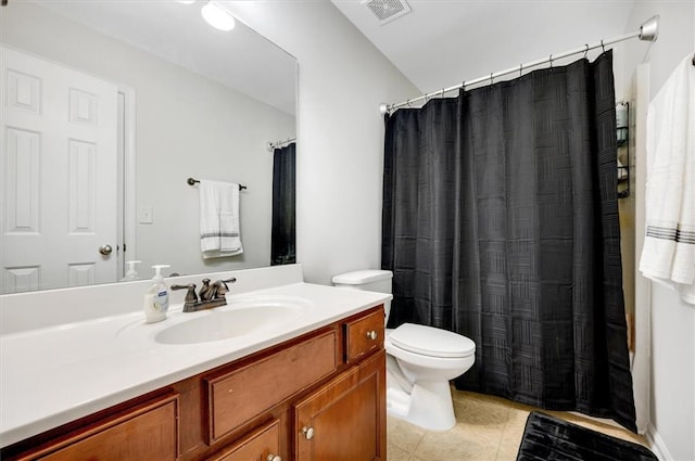 bathroom featuring tile patterned flooring, vanity, and toilet