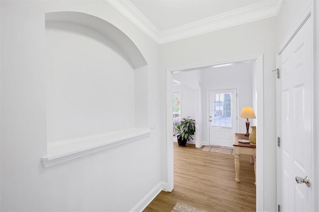 corridor with hardwood / wood-style flooring and crown molding