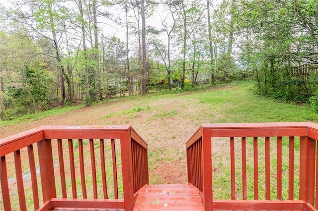 wooden terrace featuring a yard