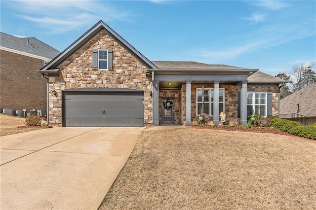 view of front of home featuring driveway, stone siding, an attached garage, and a front yard