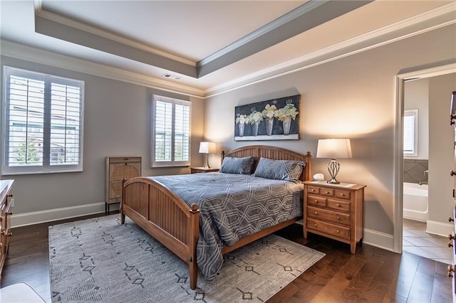 bedroom with dark wood-style floors, visible vents, a raised ceiling, and ornamental molding