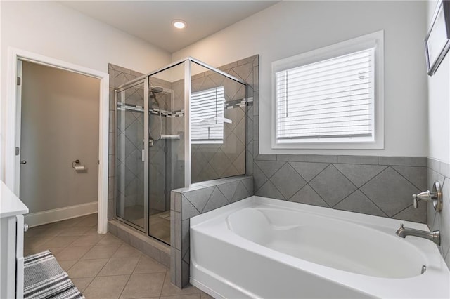 bathroom featuring baseboards, tile patterned floors, a garden tub, a shower stall, and recessed lighting