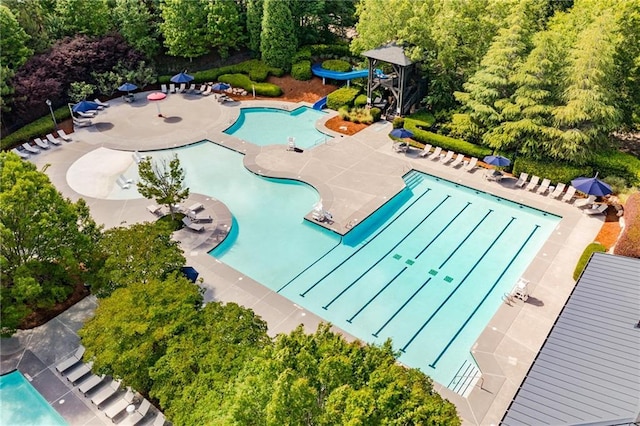 pool featuring a patio area and a water slide