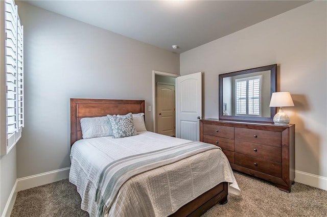 carpeted bedroom featuring baseboards