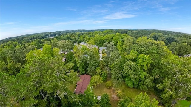 drone / aerial view featuring a wooded view