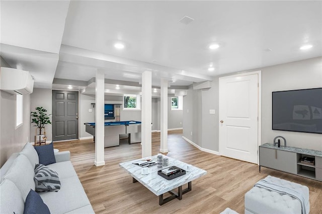 living room featuring light wood-type flooring, pool table, and a wall mounted AC