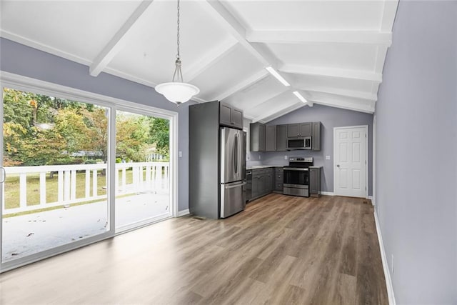 kitchen with gray cabinetry, stainless steel appliances, lofted ceiling with beams, decorative light fixtures, and hardwood / wood-style flooring