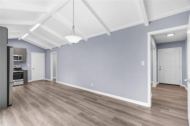 unfurnished dining area with lofted ceiling with beams, wood finished floors, and baseboards