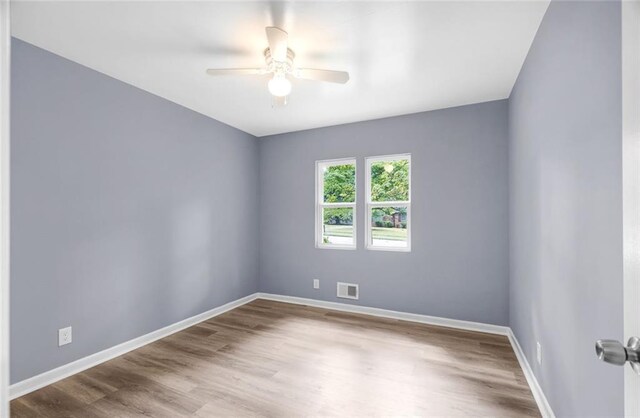 spare room with wood-type flooring and ceiling fan