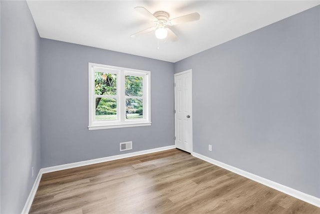 empty room with light hardwood / wood-style floors and ceiling fan