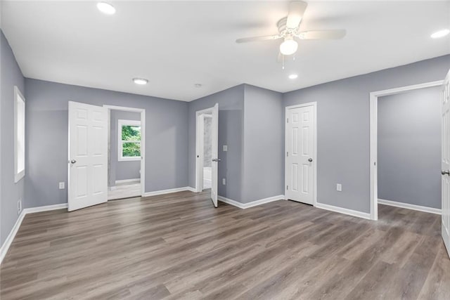 interior space featuring ceiling fan, baseboards, wood finished floors, and recessed lighting