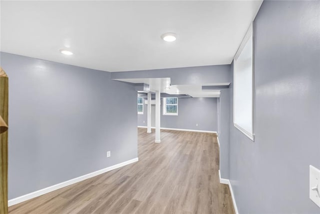 basement featuring baseboards and wood finished floors