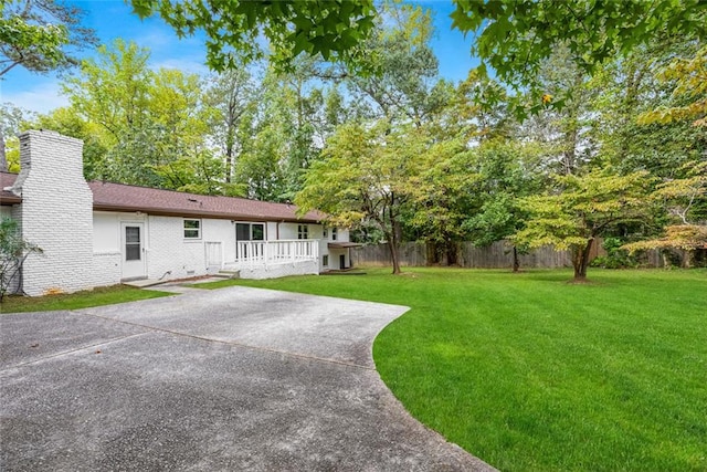 view of yard featuring fence and a wooden deck