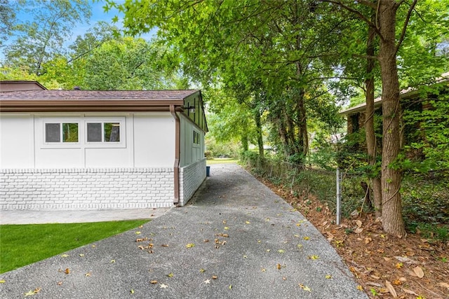 view of side of property with brick siding