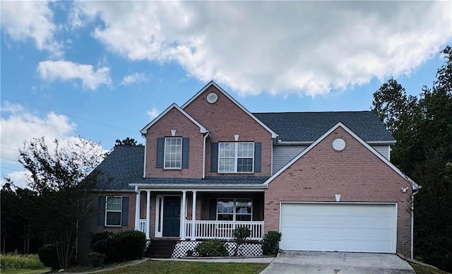 view of front of home featuring a porch and a garage