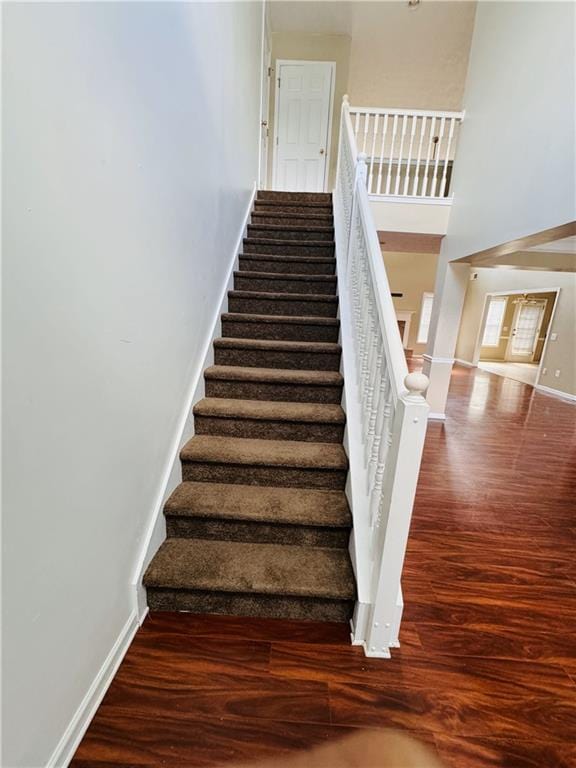 stairs featuring hardwood / wood-style floors