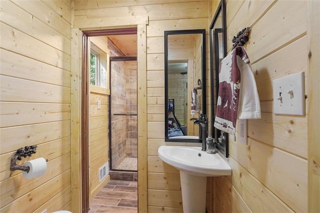 1102 Soque Wilderness Rd, Clarkesville, GA 30523 - bathroom featuring wooden walls, a shower stall, and wood finished floors